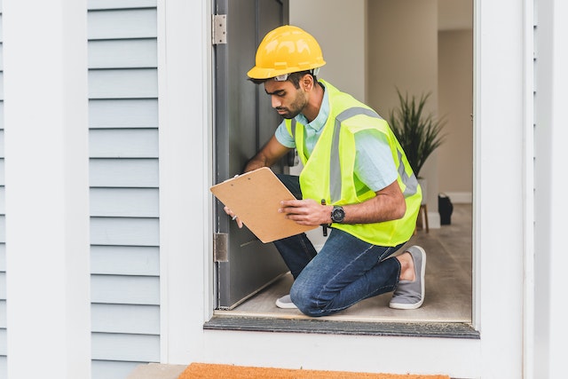 kneeling and inspecting a door